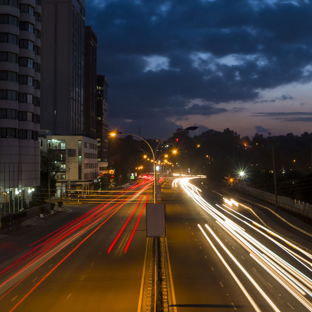 Nairobi street at night with traffic light trails.