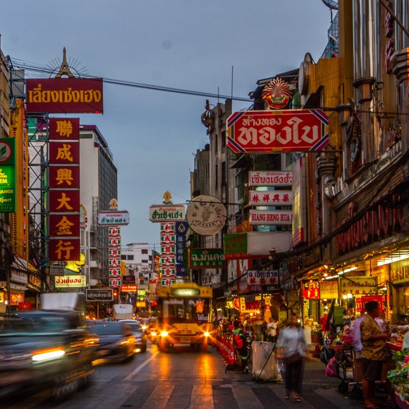 Cars and shops on Yaowarat road, Bangkok, the main street of China town.