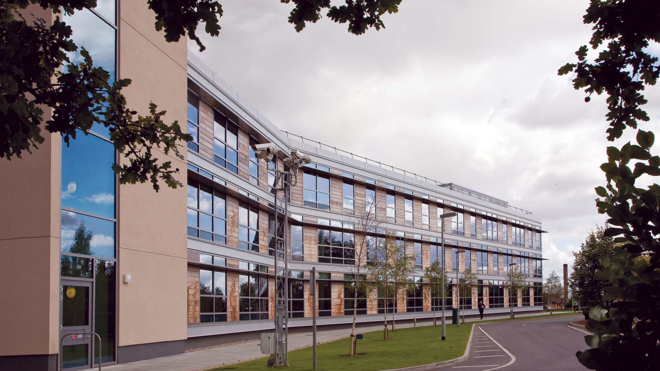 Exterior of one of our buildings at Hanslope Park. Modern offices with large glass windows.